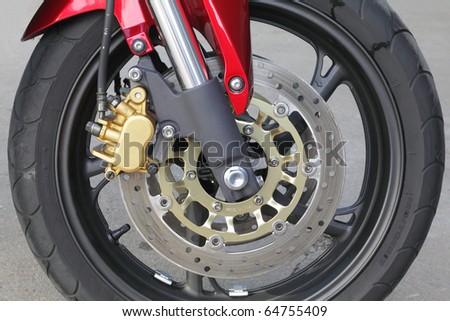 Front motorcycle disk breaks and tire in close up