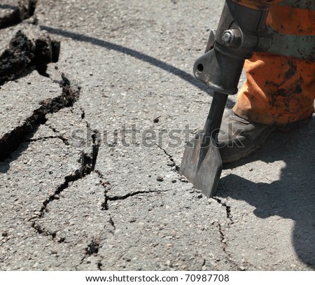 stock photo Close up of asphalt demolishing with jackhammer