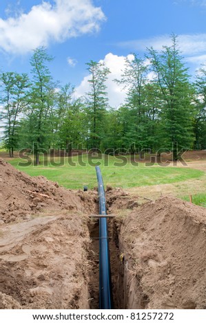 Ditch and tube for water supply at construction site