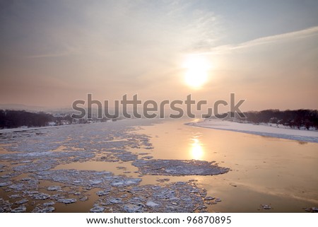 Winter sunset on Danube river with ice on water