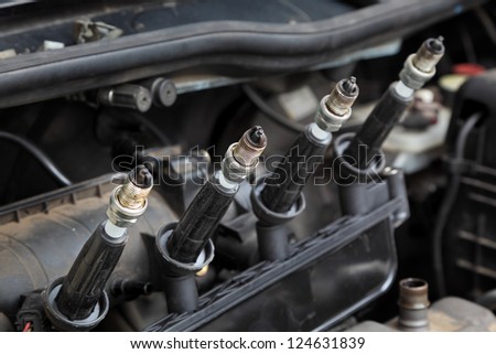 Modern car gasoline engine servicing, ignition coil and spark plugs