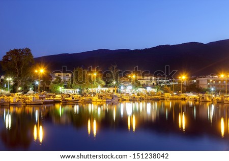 PLATAMON, GREECE - AUGUST 04: Port with boats in sunset with cafes and shops August 04, 2013, Platamonas (Greek)  is a small touristic and fishermans village in Pireia, Central Macedonia