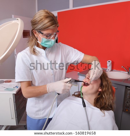 Dentist splashing teeth after drilling or polishing