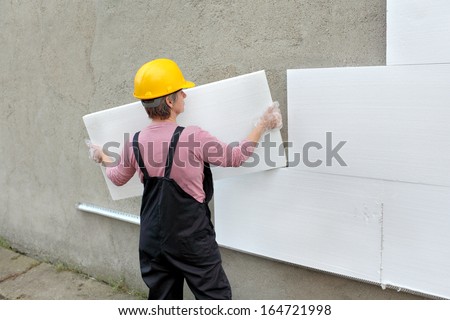Female Worker Carry Styrofoam Sheet Insulation At Construction Site