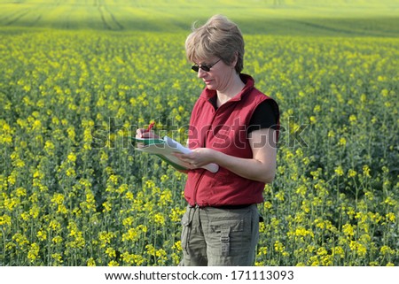 Agricultural expert inspecting quality of oil rape