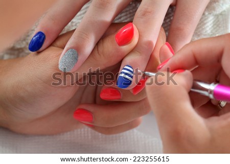 Finger nail treatment, painting lines with brush and lacquer