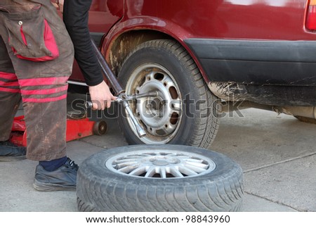 Mechanic working on a car tire in service
