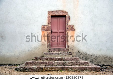 Old church side doors with steps, Perrigny sur Loire, France.