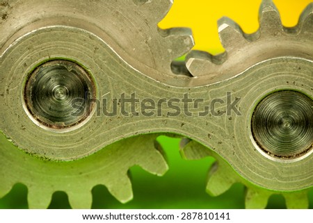 Single joint machine element consisting of two central cogwheel parts spinning together as system of connected properties, symbolizing thinking concept and mechanical approach to kinetic problems