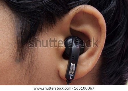 black Earphones in a Girl\'s Ear