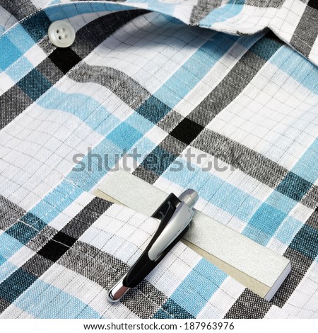pen and book in a shirt pocket