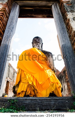 Back side of Buddha statue with Yellow robe, Thailand