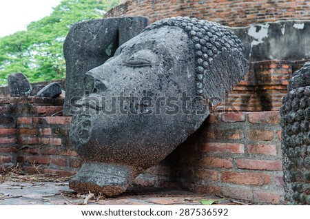 Antique Buddha head statue.Ruined Buddha statue in Ayutthay Historical Park.Public place