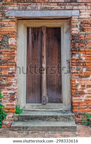 Wooden door frame in a antique sanctuary. Wat Putthaisawan, Ayutthaya Thailand. Brick wall.