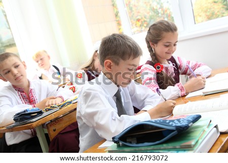 Lesson in Ukrainian schools. Children write in a notebook