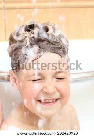 Two little sister wash the head in the bathroom