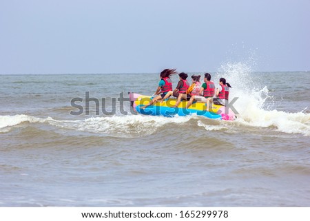 PATTAYA  - November 16 : Tourists enjoying ride a Banana Boat adventure on November 16, 2013 in Pattaya beach,Thailand