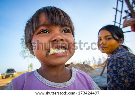 THAILAND BANGKOK - JANUARY 2014. Unidentified children smile while enjoying eating bread in his village on January 12, 2014 in Bangkok, Thailand.