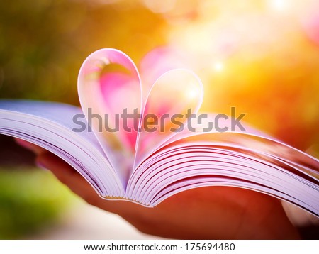 Pages of a book curved into a heart shape.