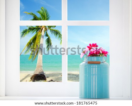 Bouquet of artificial flowers in a window to look through the window at the sea. relaxation concept