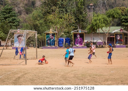 PHETCHABURI, Thailand - FEBRUARY 08, 2015: Karen hill tribel boy playing football in ground field in the school at Ban Bangkloy Phetchaburi, Thailand