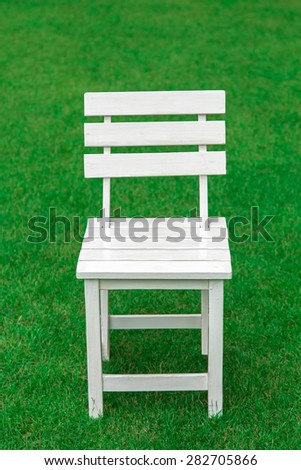 wood chair on nature green grass  background. concept for product display template