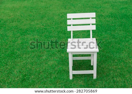 wood chair on nature green grass  background. concept for product display template