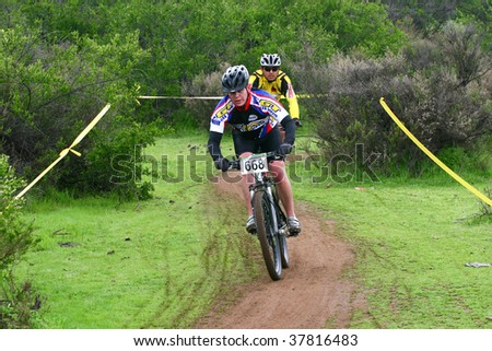 SANTIAGO, CHILE - SEPTEMBER 27: Rider number 668 being chased closely during a descent on Alpes Cup, mountain bike competition on September 27, 2009 in Santiago, Chile.