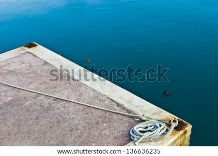 Hawser rope in port against blue sea
