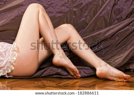 Woman legs soft skin on velvet background
