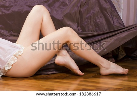 Woman legs soft skin on velvet background