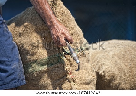 Old man hands holding juta sack in Asia