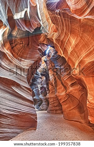 Antelope Canyon view with light rays on sand floor