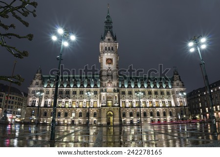 hamburg city hall at night under heavy rain