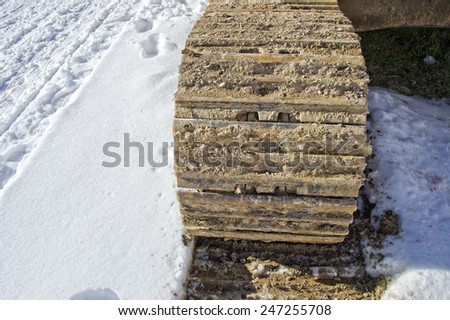 caterpillar track detail on snow background