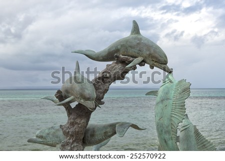 Dolphin copper statue by the sea