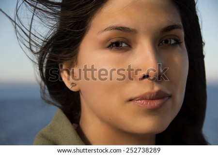 beautiful black hair mexican woman on the sea background
