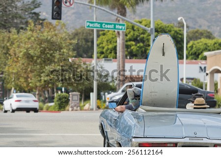 surf board in a vintage car in California