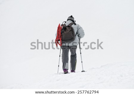 isolated snow shoe trekker walking on the snow