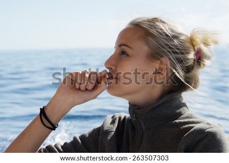 Grey eyes beautiful blonde girl on ocean water background