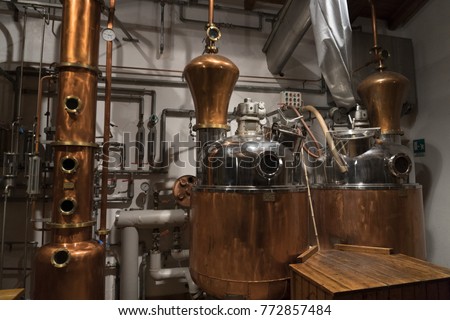 Copper still alembic inside distillery to distill grapes and produce spirits