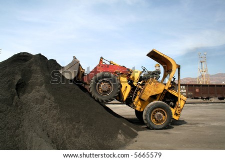 Front loader stacking copper ore.