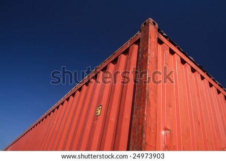 Detail of an open top red cargo container.