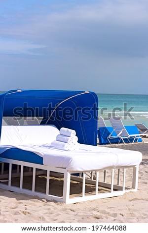 Spa bed on the ocean beach. Massage bed at the water edge with towels.