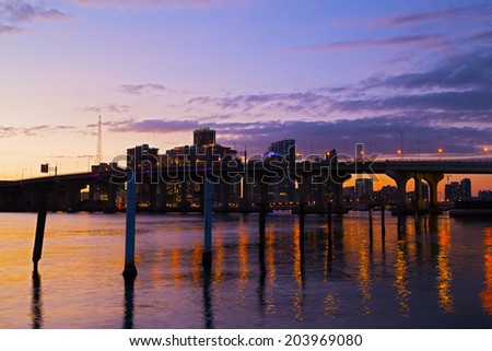 Miami city skyline with the bridge at sunset. Colorful buildings and bridge reflections of Miami downtown.