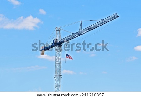 Tower crane with American flag. Patriotic construction crane.