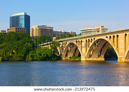Key Bridge in Washington DC with office building on background. The bridge photographed from Georgetown Park in early summer morning.