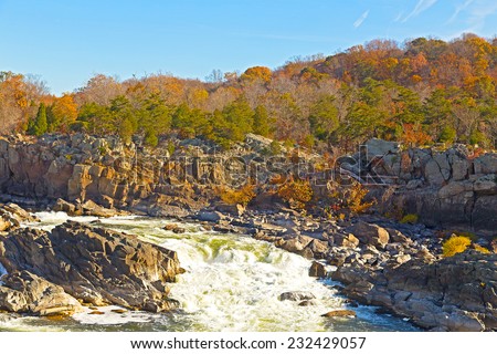 Great Falls National Park in autumn, Virginia USA. Potomac river with rocky banks and colorful autumn trees.