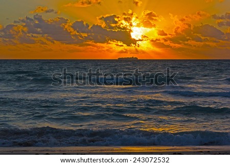 Dramatic sunrise with clouds over the ocean. Cloudy skies over the ocean.