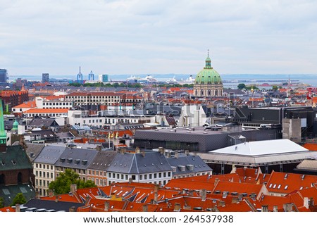 Roof tops of Copenhagen, Denmark. Panorama of colorful roof tops and old churches in Copenhagen, Denmark